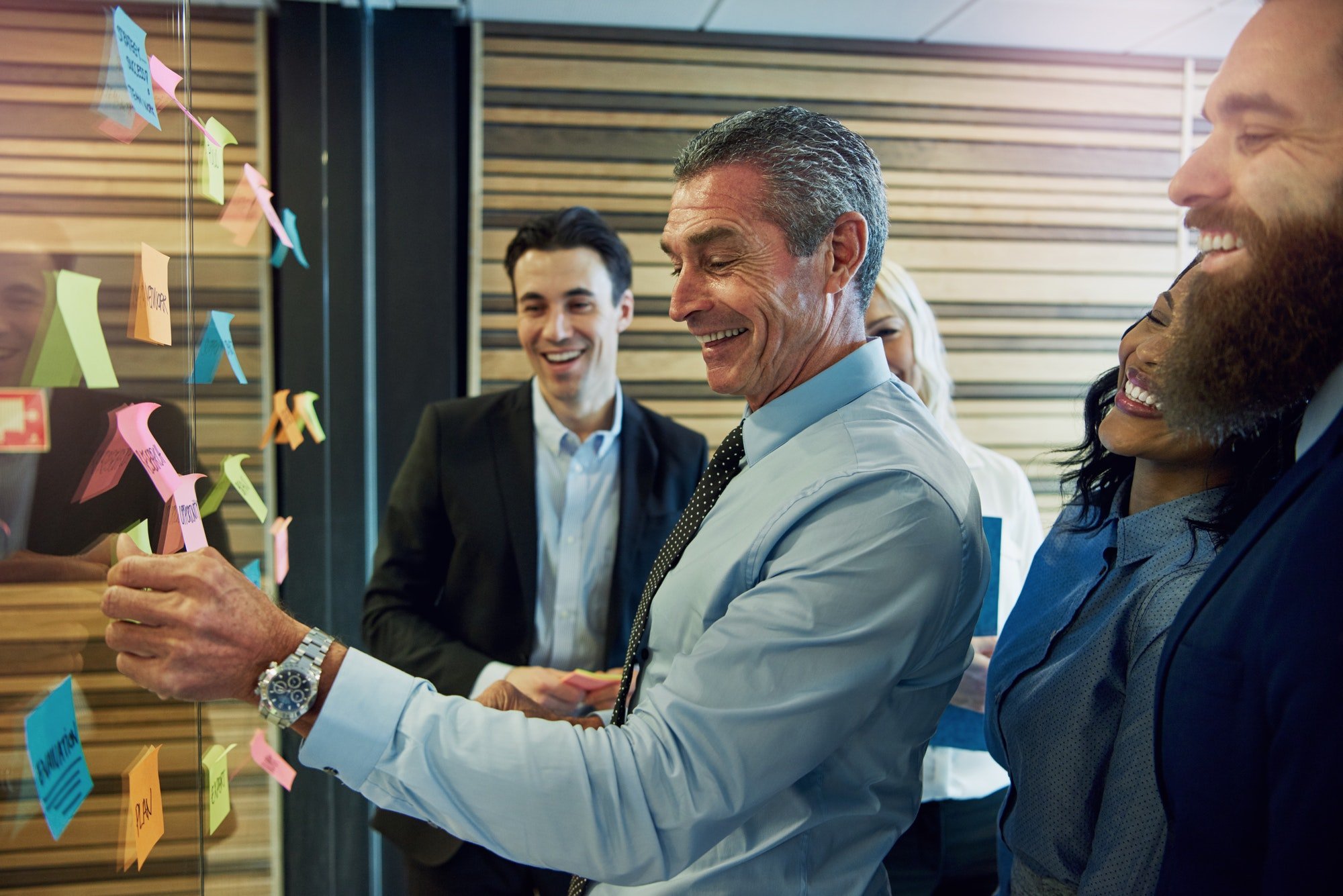 Smiling businesspeople with sticky notes